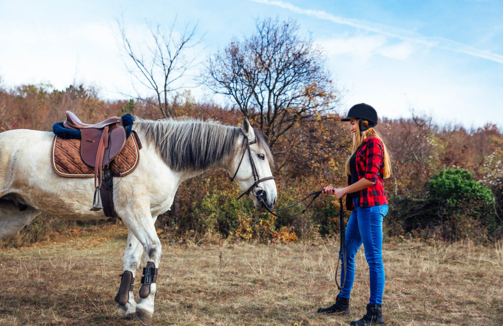 Lady with her horse practising natural horsemanship.