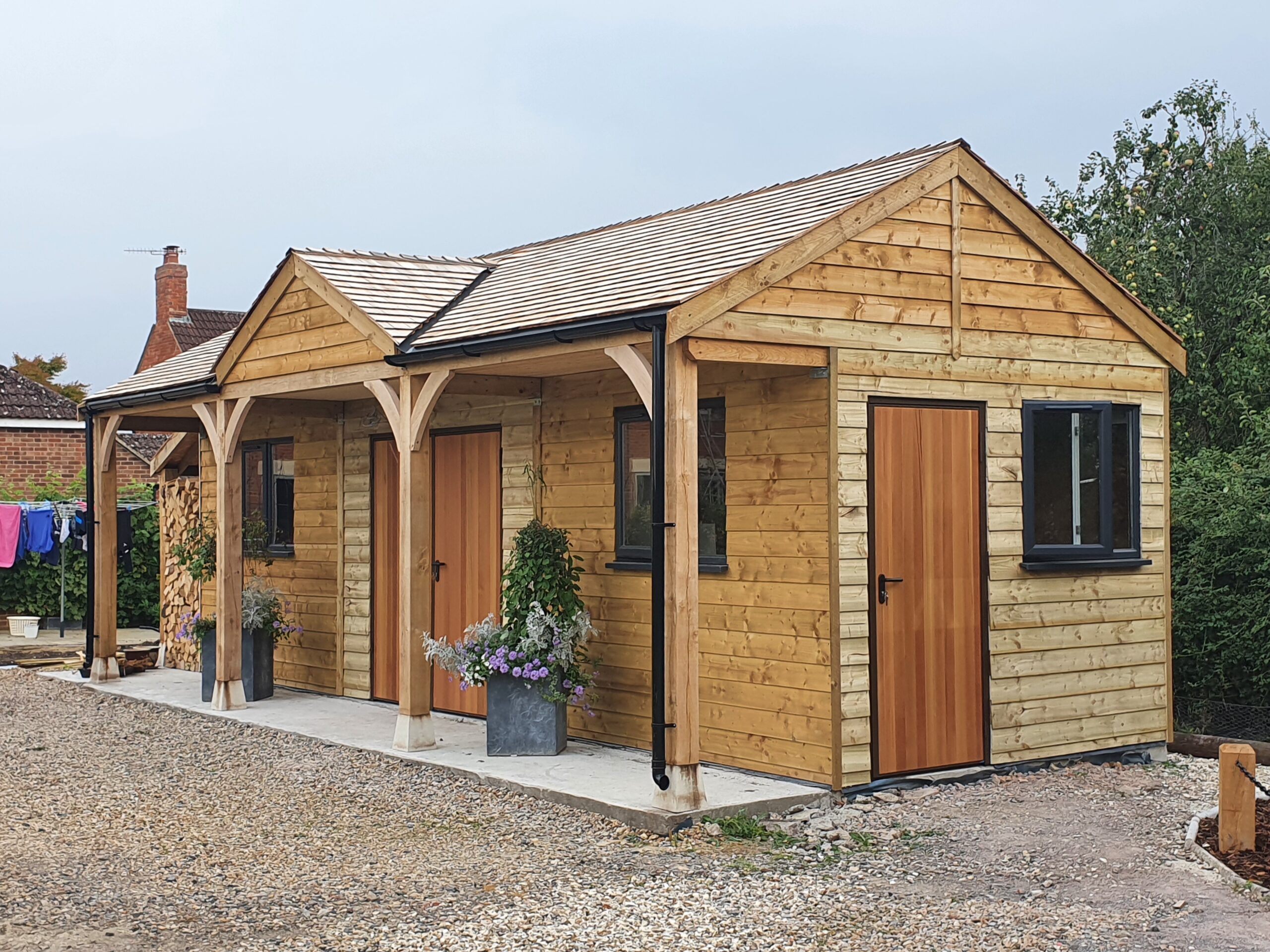 Bespoke Garage with Cedar Shingle Roof, UPVC Anthracite Windows, and Cedar-wood Doors